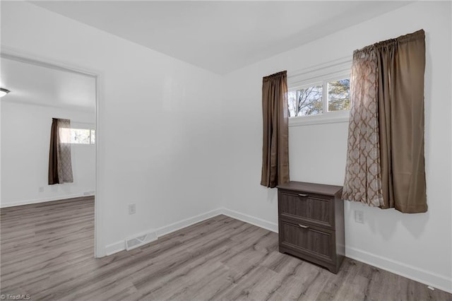 unfurnished room with a wealth of natural light and light wood-type flooring