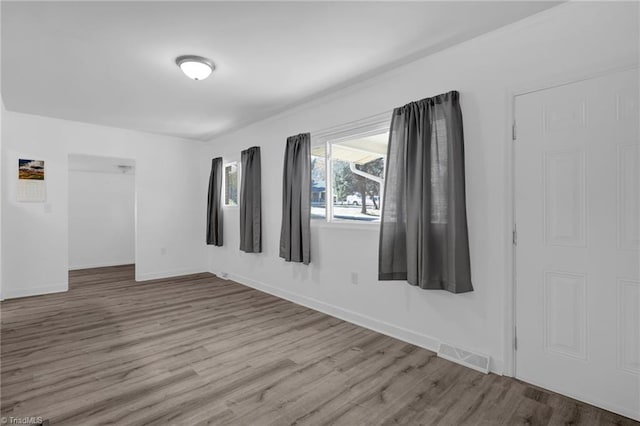 unfurnished room with light wood-type flooring