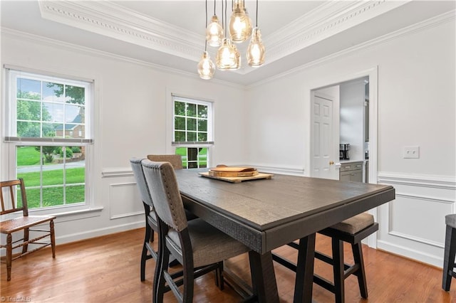3401 Lochurst Ct, Pfafftown, NC 27040 - dining room with a chandelier, crown molding, light wood-style floors, a wainscoted wall, and a decorative wall