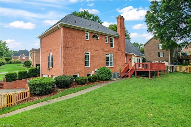 3401 Lochurst Ct, Pfafftown, NC 27040 - back of house featuring a chimney, an attached garage, a wooden deck, a yard, and central air condition unit