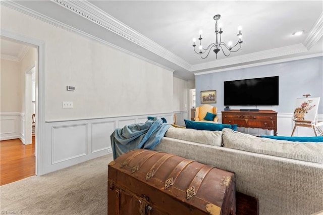 3401 Lochurst Ct, Pfafftown, NC 27040 - living area featuring a chandelier, wainscoting, ornamental molding, light carpet, and a decorative wall