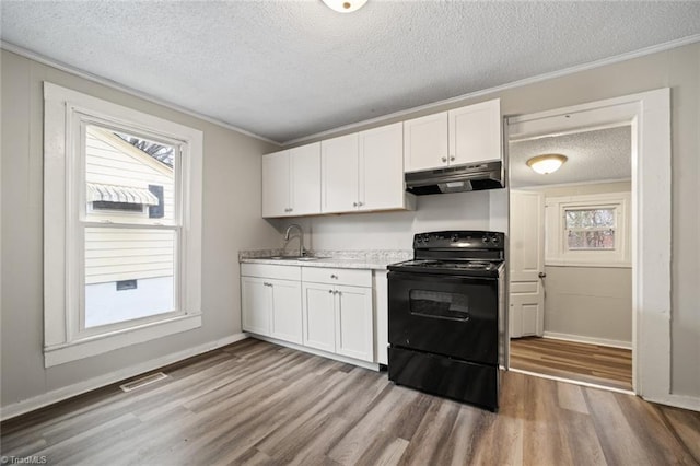 kitchen with light hardwood / wood-style flooring, sink, black electric range oven, and white cabinets