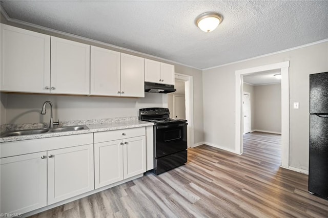 kitchen featuring black appliances, light hardwood / wood-style floors, ornamental molding, sink, and white cabinetry