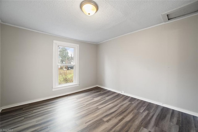 unfurnished room with ornamental molding, dark hardwood / wood-style floors, and a textured ceiling