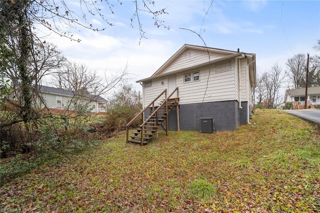 rear view of house featuring central AC unit