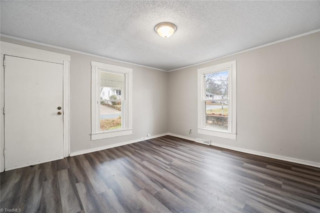 interior space with a textured ceiling, crown molding, and dark hardwood / wood-style floors