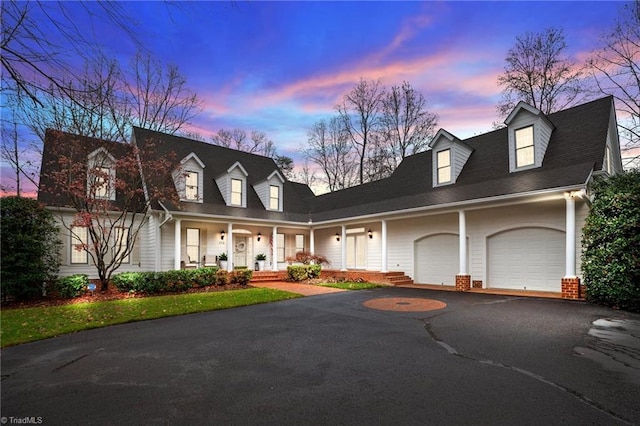 cape cod-style house with covered porch