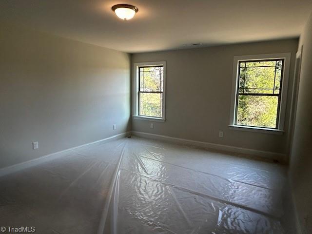 unfurnished room featuring plenty of natural light