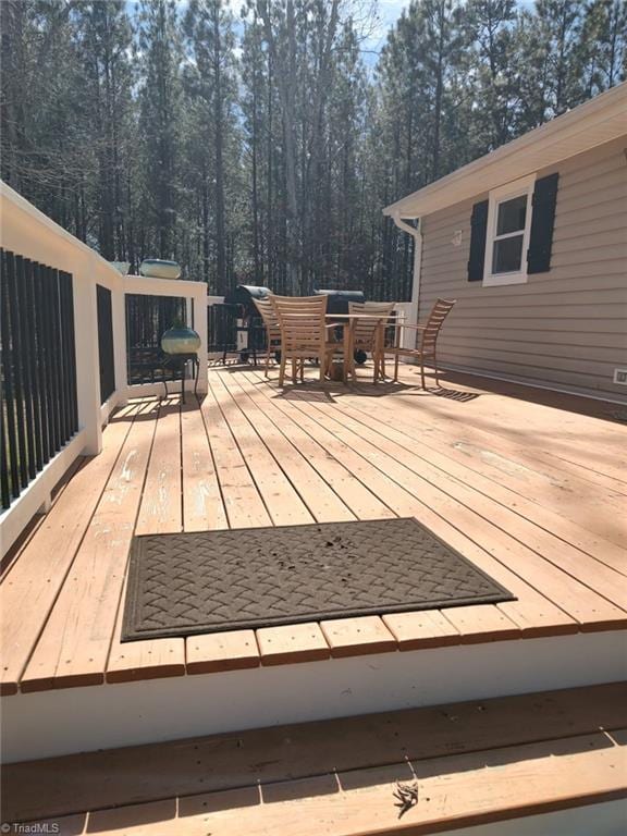 wooden terrace featuring outdoor dining area