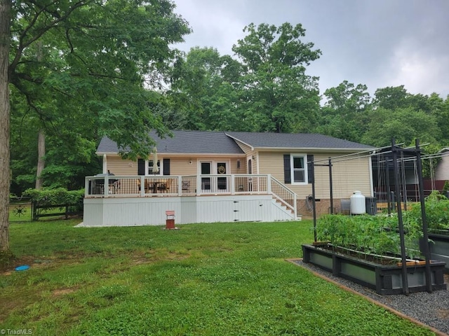 back of house with a vegetable garden, stairway, fence, a deck, and a yard