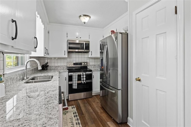 100 Monroe Dr, Lexington, NC 27295 - kitchen featuring dark wood-style flooring, appliances with stainless steel finishes, a sink, decorative backsplash, and ornamental molding
