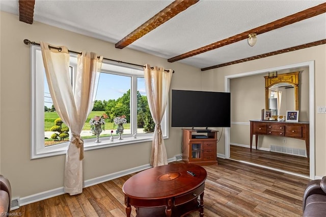 100 Monroe Dr, Lexington, NC 27295 - living room with visible vents, beam ceiling, wood finished floors, baseboards, and a textured ceiling