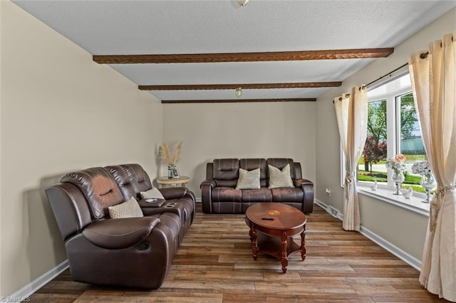 100 Monroe Dr, Lexington, NC 27295 - living room with baseboards, beamed ceiling, a textured ceiling, and wood finished floors