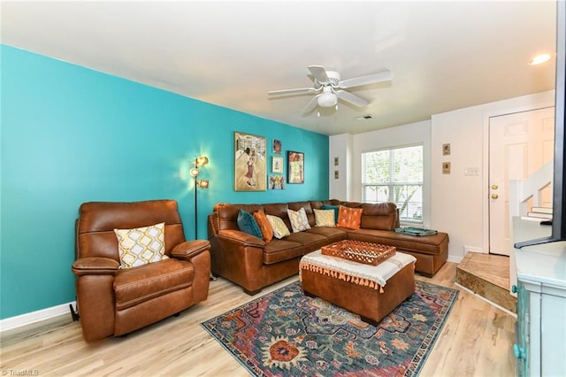 living room featuring light hardwood / wood-style flooring and ceiling fan