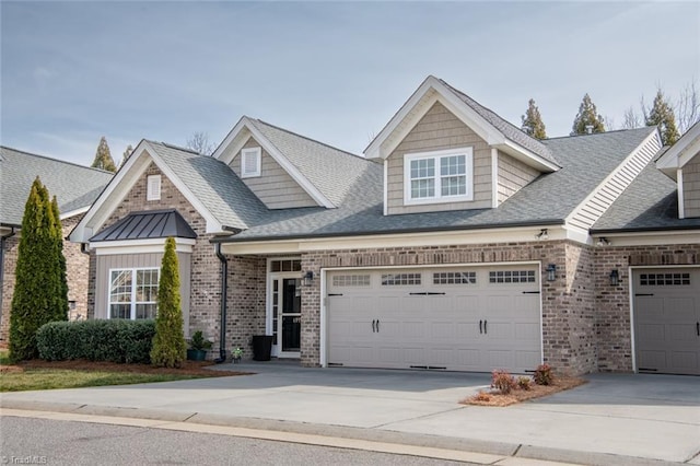 view of front facade with an attached garage, concrete driveway, and brick siding