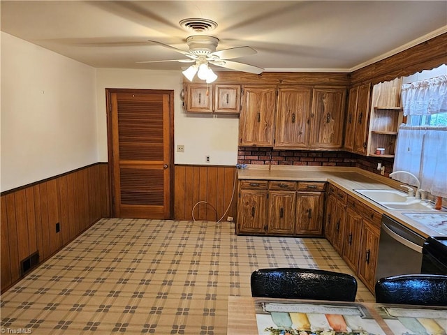 4875 Follansbee Rd, Winston-Salem, NC 27127 - kitchen featuring a sink, wainscoting, ceiling fan, wooden walls, and light countertops