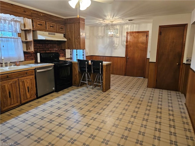 4875 Follansbee Rd, Winston-Salem, NC 27127 - kitchen with under cabinet range hood, dishwasher, black electric range oven, a sink, and wainscoting