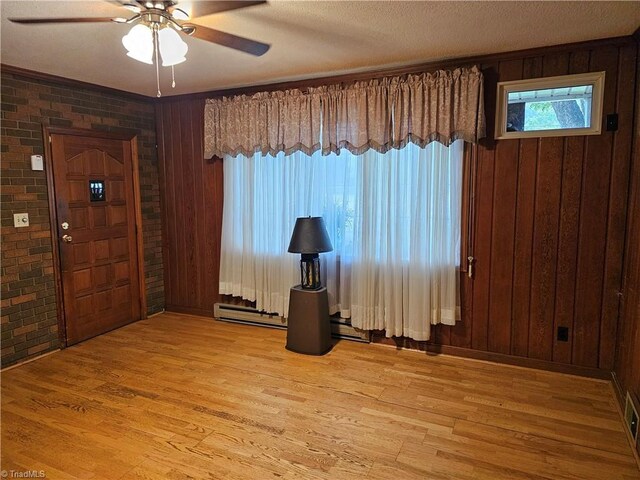 4875 Follansbee Rd, Winston-Salem, NC 27127 - entrance foyer featuring ceiling fan, wood finished floors, wood walls, and brick wall