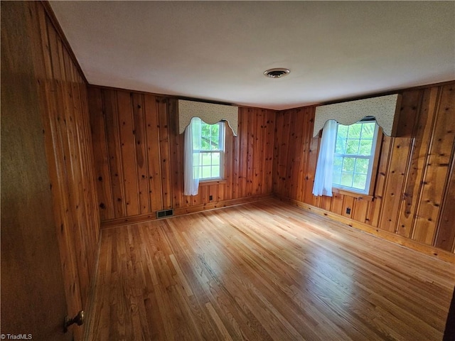 4875 Follansbee Rd, Winston-Salem, NC 27127 - unfurnished room with wood finished floors, plenty of natural light, wooden walls, and baseboards