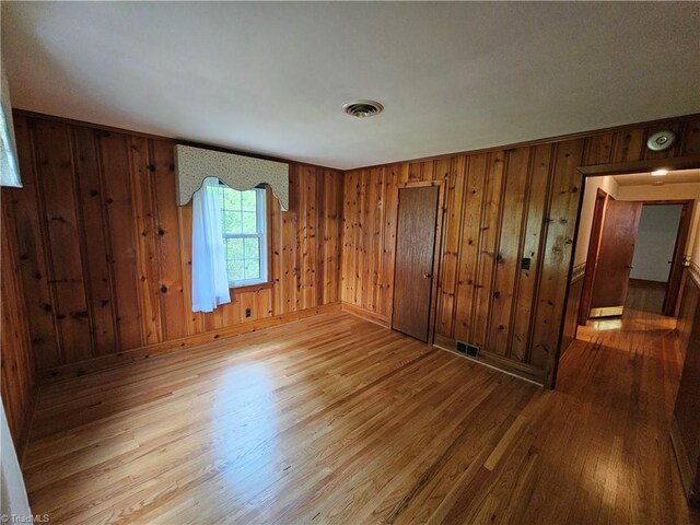 4875 Follansbee Rd, Winston-Salem, NC 27127 - unfurnished bedroom with wood finished floors, wood walls, and baseboards