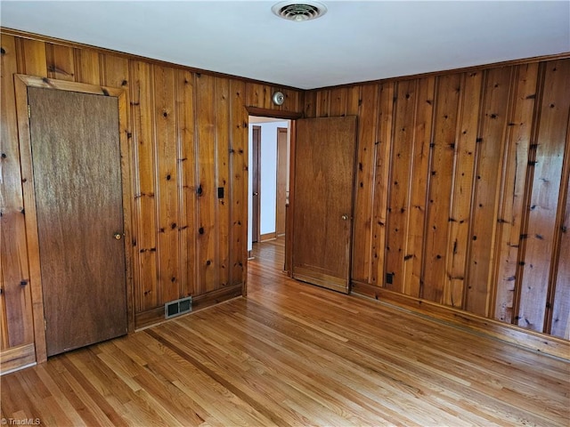 4875 Follansbee Rd, Winston-Salem, NC 27127 - unfurnished bedroom featuring light wood-type flooring, wood walls, and a closet