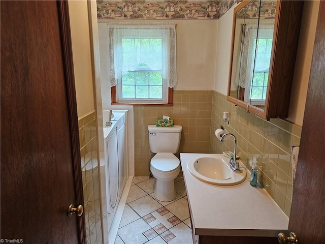 4875 Follansbee Rd, Winston-Salem, NC 27127 - bathroom featuring washing machine and clothes dryer, wainscoting, toilet, tile patterned floors, and vanity