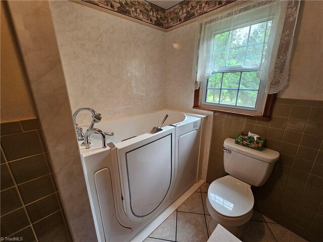 4875 Follansbee Rd, Winston-Salem, NC 27127 - full bath featuring a bath, toilet, tile walls, tile patterned floors, and a wainscoted wall