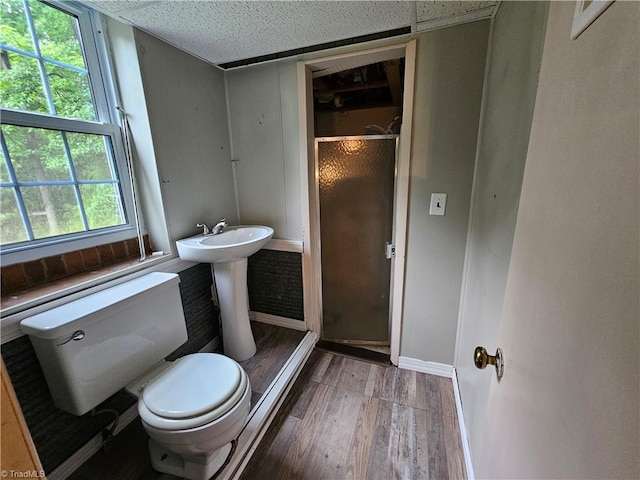 4875 Follansbee Rd, Winston-Salem, NC 27127 - bathroom featuring toilet, wood finished floors, a shower stall, and baseboards