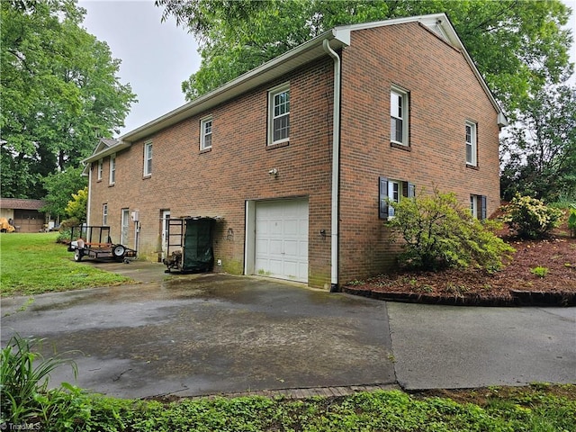 4875 Follansbee Rd, Winston-Salem, NC 27127 - view of side of home featuring a garage, concrete driveway, and brick siding