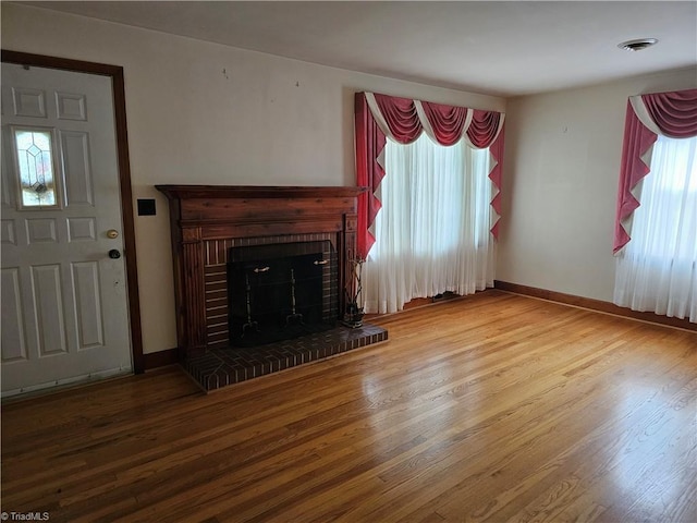 4875 Follansbee Rd, Winston-Salem, NC 27127 - unfurnished living room featuring wood finished floors, a fireplace, and baseboards
