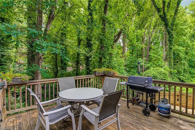 wooden deck featuring outdoor dining area and area for grilling