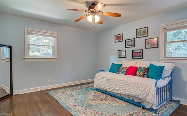 bedroom with dark wood-style floors, ceiling fan, and baseboards