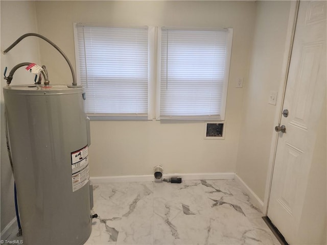 laundry room with laundry area, electric water heater, marble finish floor, and baseboards