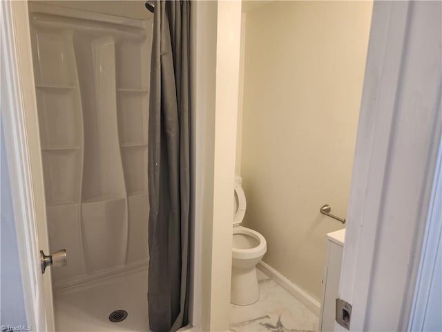 full bath with toilet, marble finish floor, a shower stall, and baseboards