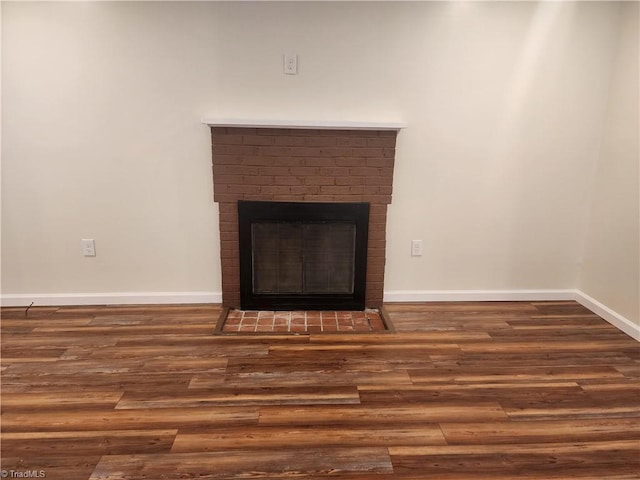 details with a brick fireplace, baseboards, and wood finished floors