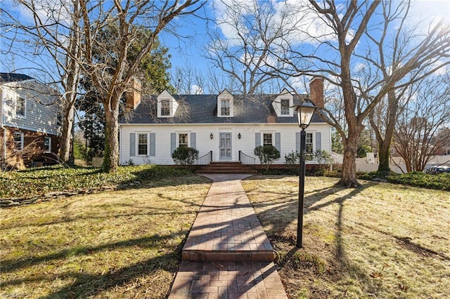 cape cod-style house featuring a front lawn