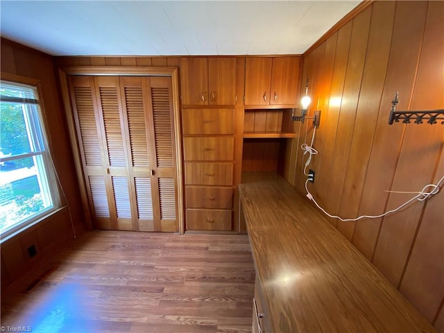 interior space featuring wooden walls and hardwood / wood-style floors