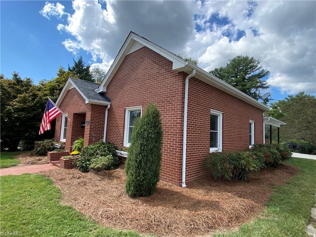 view of side of home featuring a lawn