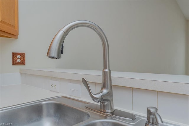 details with light countertops, built in desk, and a sink