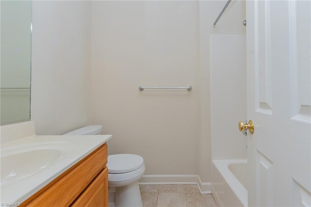 bathroom with vanity, toilet, baseboards, and tile patterned flooring