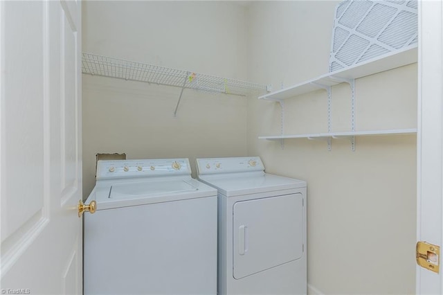 washroom featuring laundry area and washing machine and clothes dryer