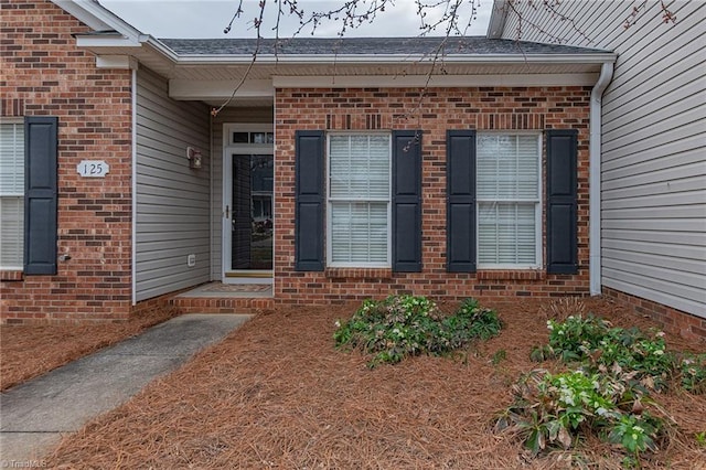 entrance to property with brick siding