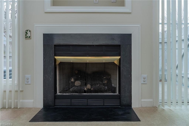 room details with a fireplace with flush hearth and carpet