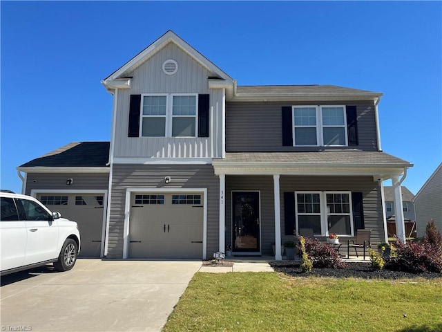 front of property with covered porch, a garage, and a front lawn