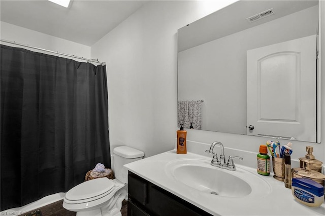 bathroom with vanity, hardwood / wood-style floors, and toilet