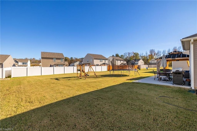 view of yard with a playground, a patio area, a gazebo, and a trampoline