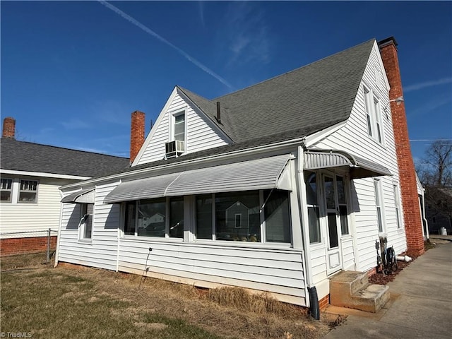 exterior space featuring cooling unit and a lawn