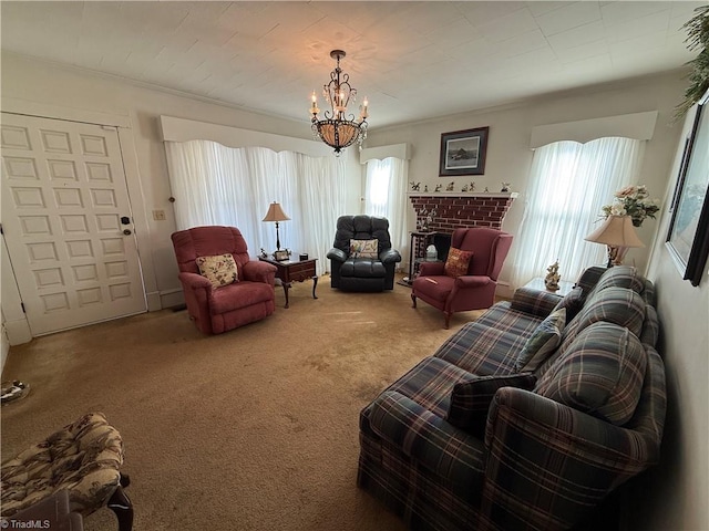 living room featuring an inviting chandelier, a brick fireplace, a healthy amount of sunlight, and carpet flooring