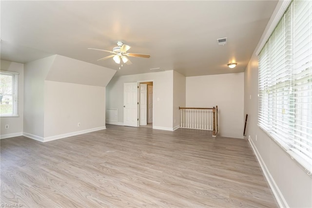 bonus room with light wood-style floors, visible vents, baseboards, and a ceiling fan