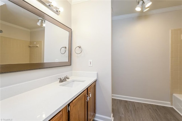 bathroom with vanity, ornamental molding, tub / shower combination, and wood finished floors